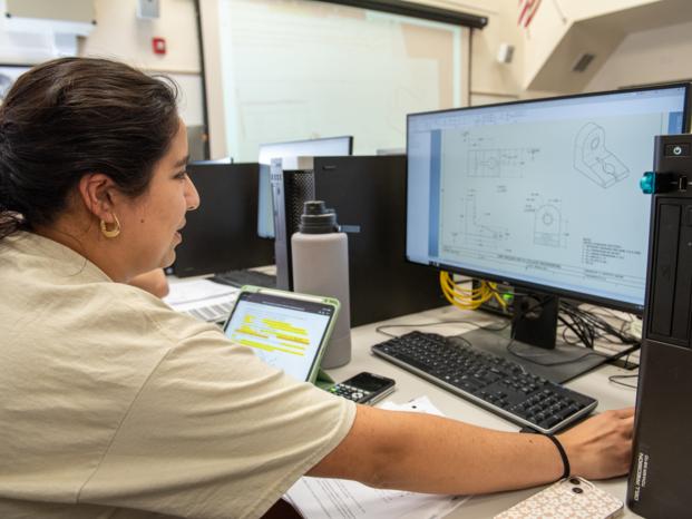 engineer in front of the computer creating 3d object