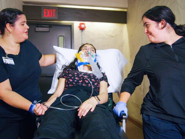 two medical technician with 1 patient