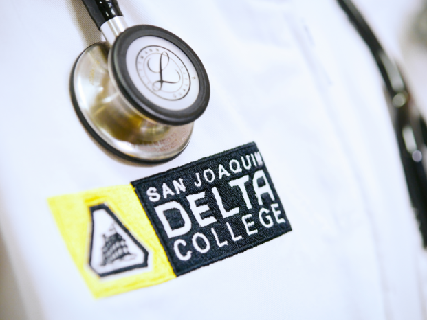 Delta logo on the doctor's coat