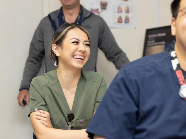 A radiology technician student smiles during class