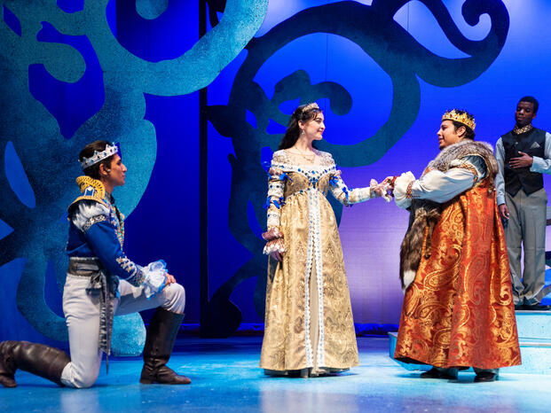 Three Delta students performing on stage during a drama play