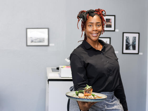 Student holding a plate of salmon