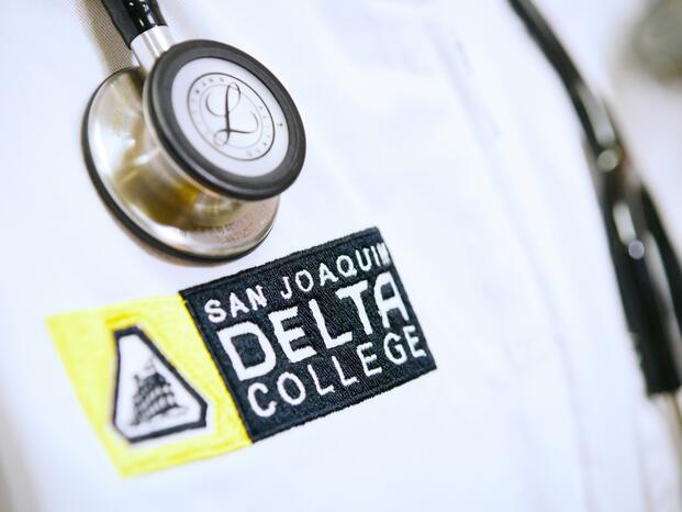 Close up of nursing uniform and stethoscope