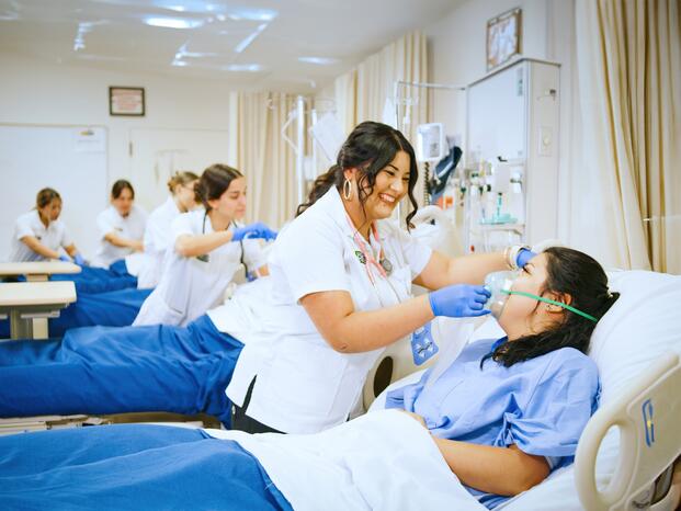 Nursing student assisting patient