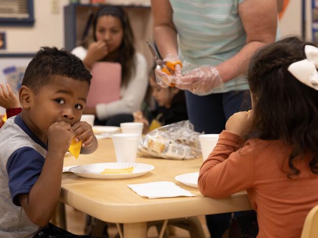 A boy enjoys snack at the Child Development Center