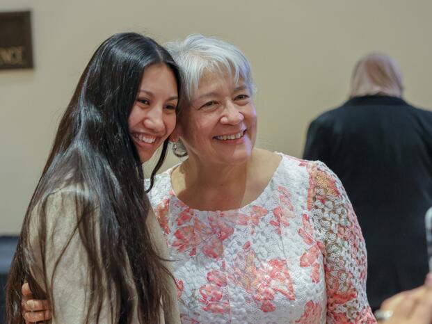 A student poses for photos with the MESA coordinator