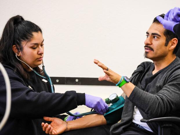 An instructor talks with EMT students