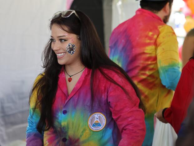 A Chemistry Club student smiles while teaching children about science
