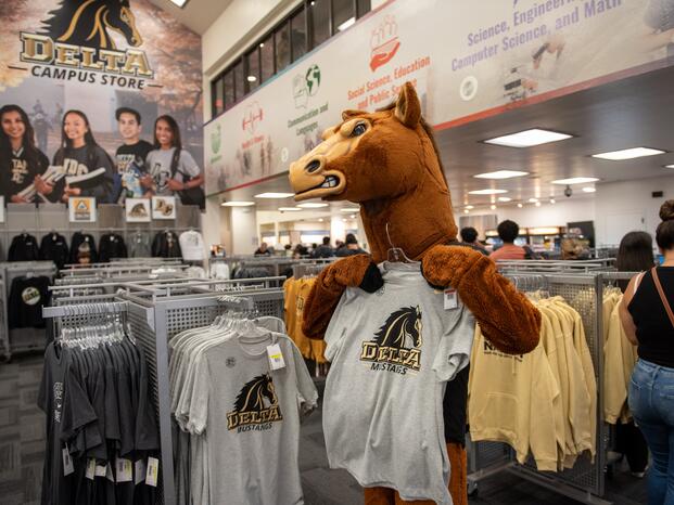 Fierce holding Delta t-shirt inside of the Bookstore