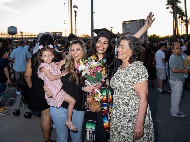 A student and her family pose for photos after Commencement