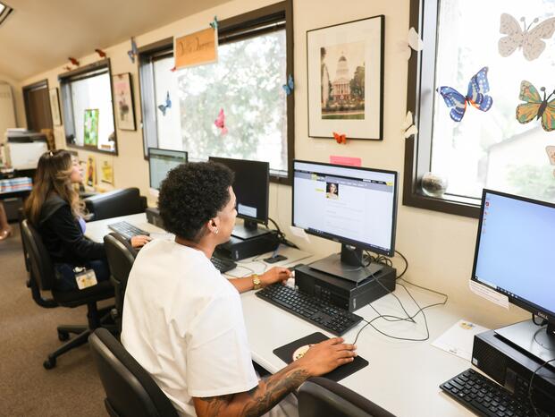 A student uses a computer at the Dreamers Success Center