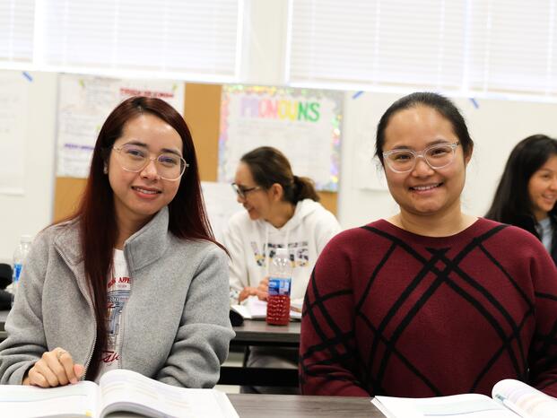 ESL students smile during class