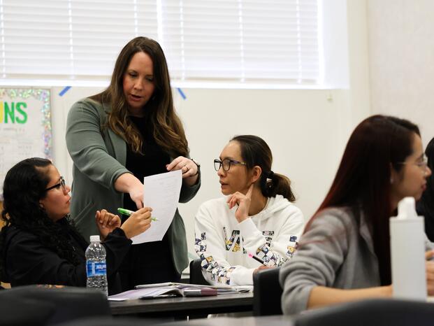 An ESL instructor speaks with students