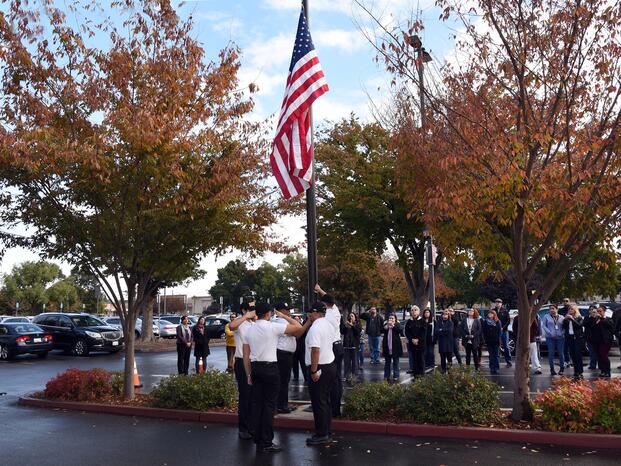 Flag raising outside the DeRicco Building