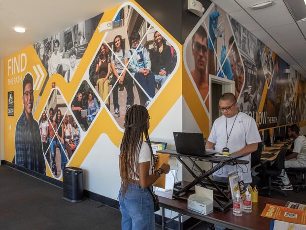 Student being helped with paperwork in the Delta Connect Center