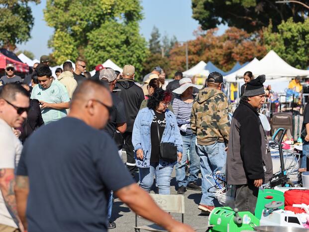 Crowds of people checking out items at The Market