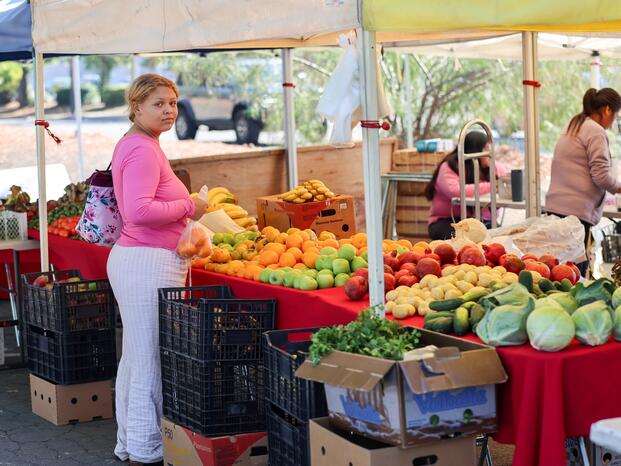 A shopper buys fresh produce at The Market at Delta College