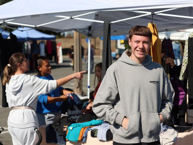 A patron at The Market stands near a booth