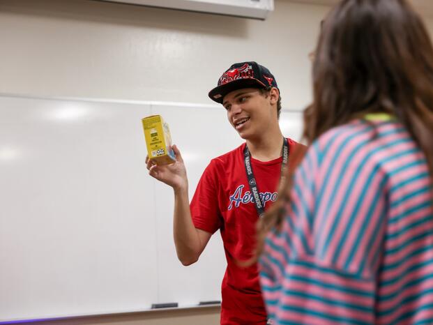 Photo of a DSPS student reading a nutrition label on a box of food