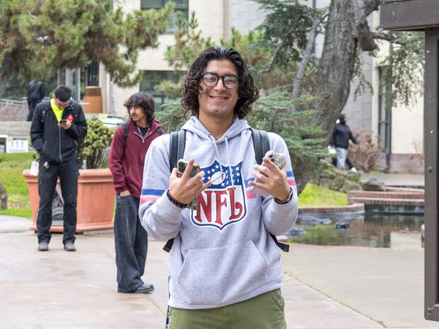 A student poses for a photo in the Delta College Quad