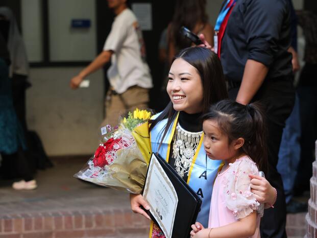 A graduating student celebrates with her daughter