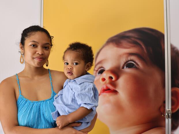 A student and her child pose for a photo outside one of the new lactation pods.