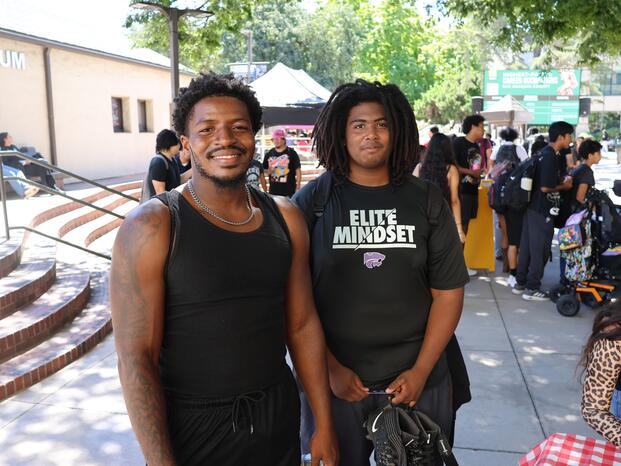 Two students pose for a photo in the Delta College quad