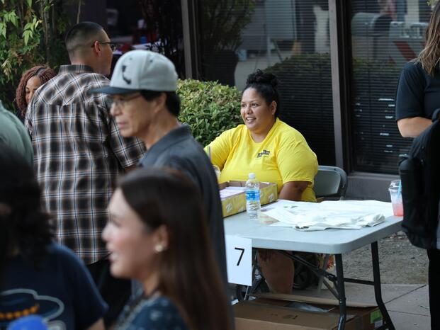 A Delta staff member talks with community members at the annual College Night