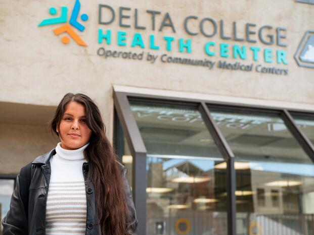 A student stands in front of the Delta College Health Center