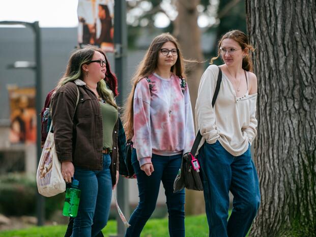 A group of Delta students strolls across campus