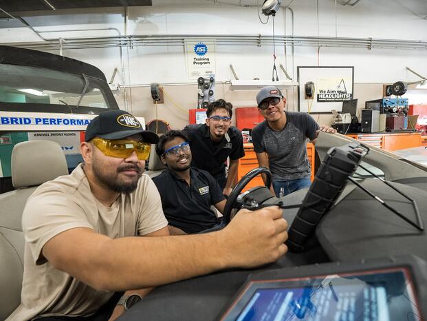 Photo of Delta students working on an electric vehicle