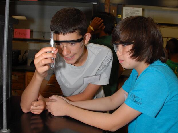 Two young boys looking at a testtube