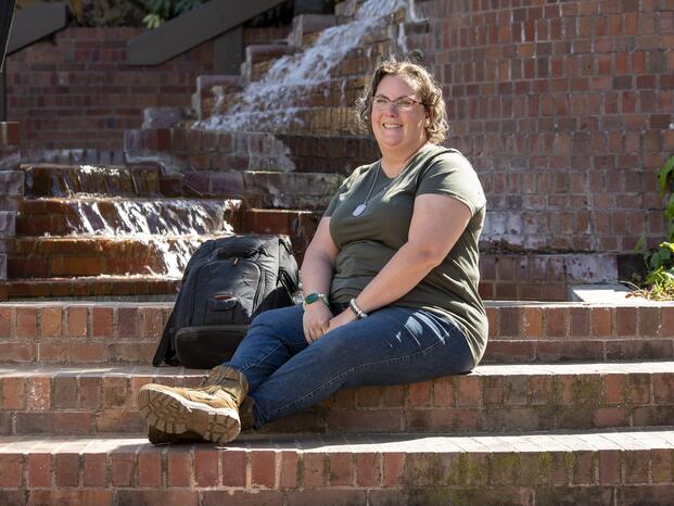 Photo of a student sitting by the Budd water fountain.