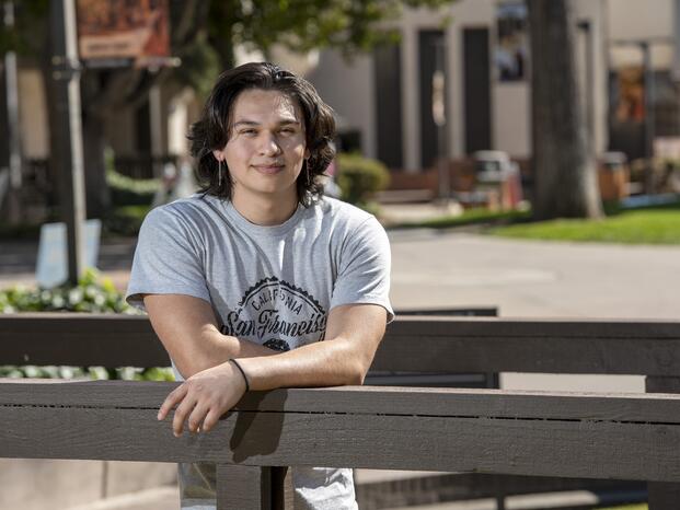 A student poses for a photo on the Delta College bridge near the Quad