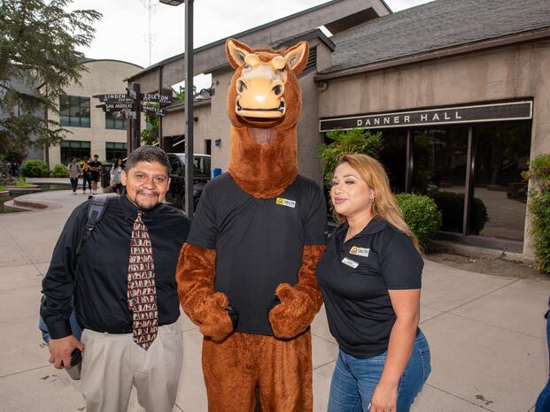 A photo of Fierce the Mustang posing with Prof. Aguilar and Tina Leal