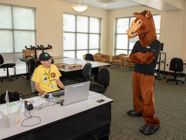 Fierce the Mustang hangs out with the Mustang Tech Squad