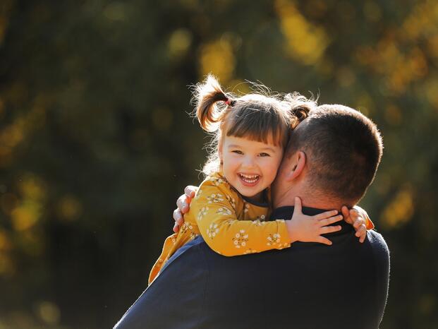 Photo of a foster parent hugging his child