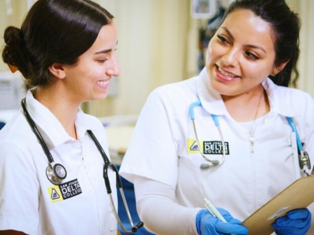Two nursing students studying a patient's chart