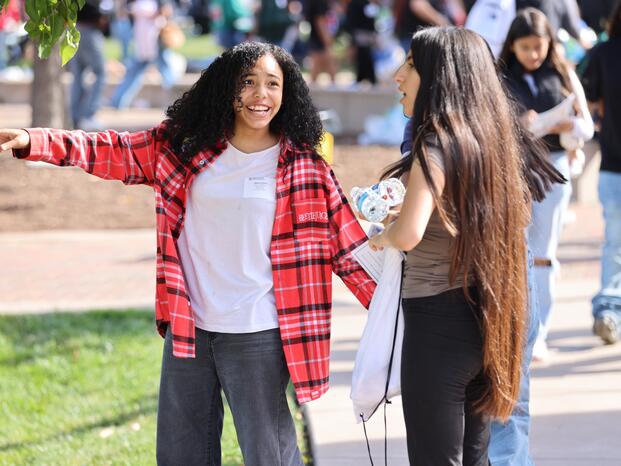 Photo of two high school students talking and laughing during the annual LULAC Youth Leadership Conference.