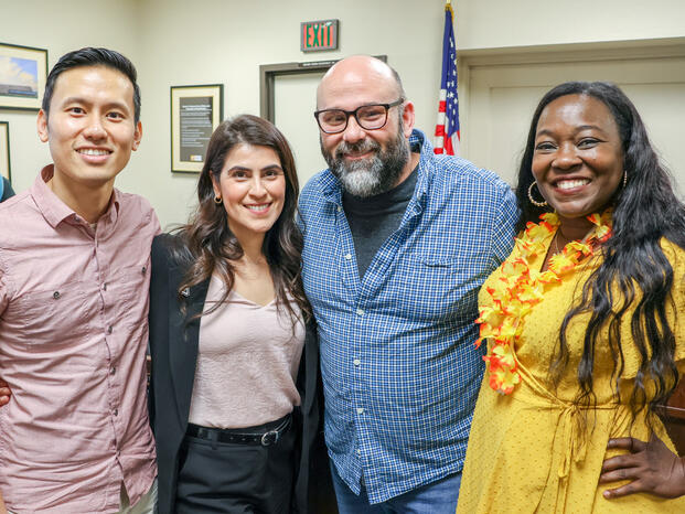 Four Delta faculty members smile for the camera 