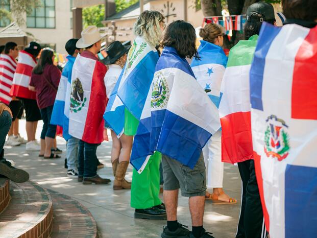 A group of students each wrapped in a flag.