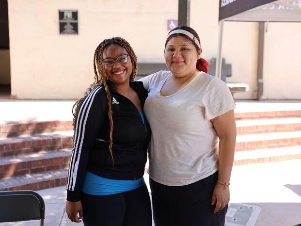 Students smiling while tabling at Club Rush event