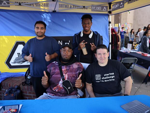Students smiling while tabling at Club Rush event