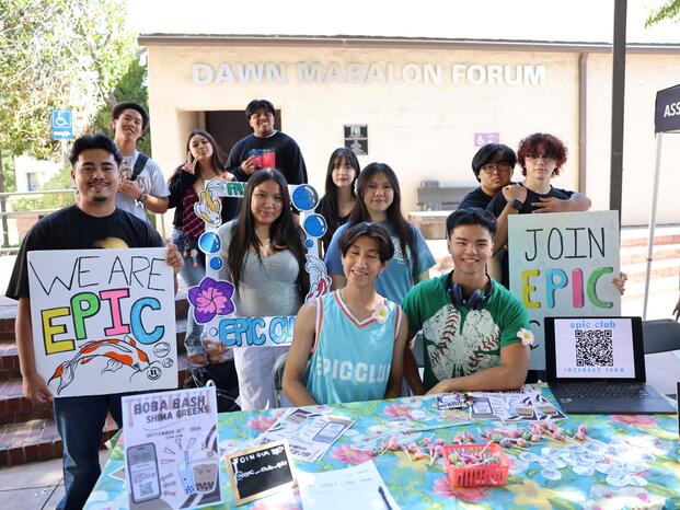 Students smiling while tabling at Club Rush event