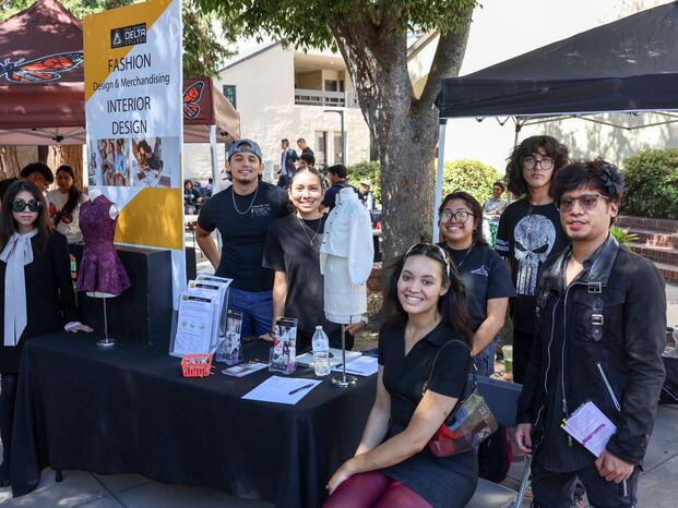 Students smiling while tabling at Club Rush event