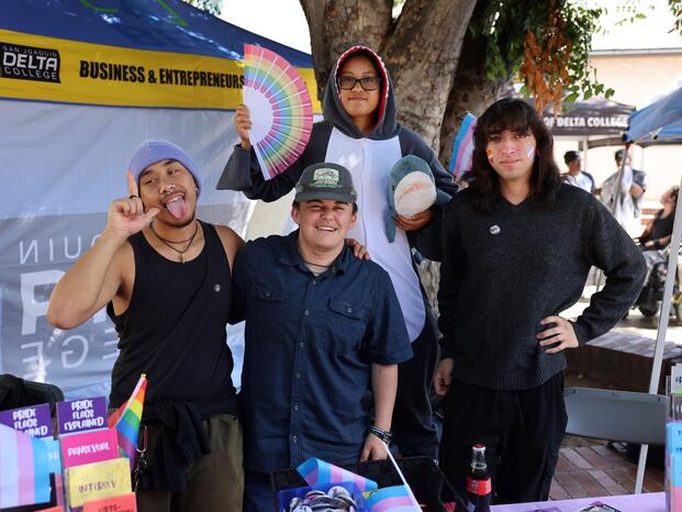 Students smiling while tabling at Club Rush event