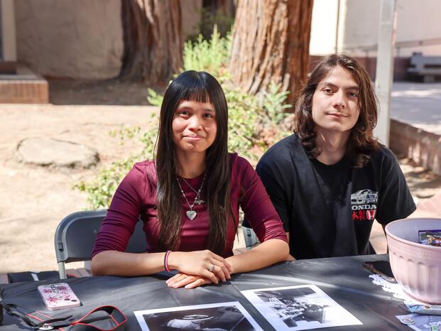 Two students smiling while tabling at Club Rush event