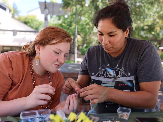 Two students sitting at their club's table during Club Rush