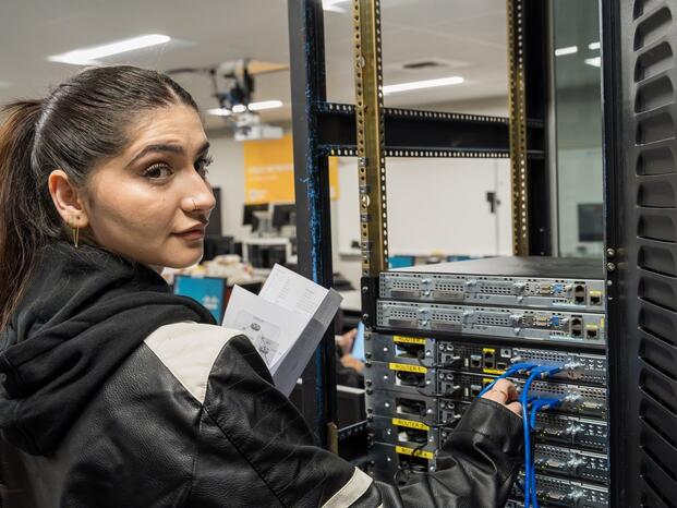 Photo of a student plugging in wires