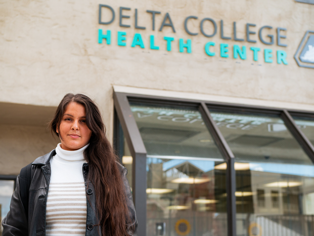 Student in front of Health Center